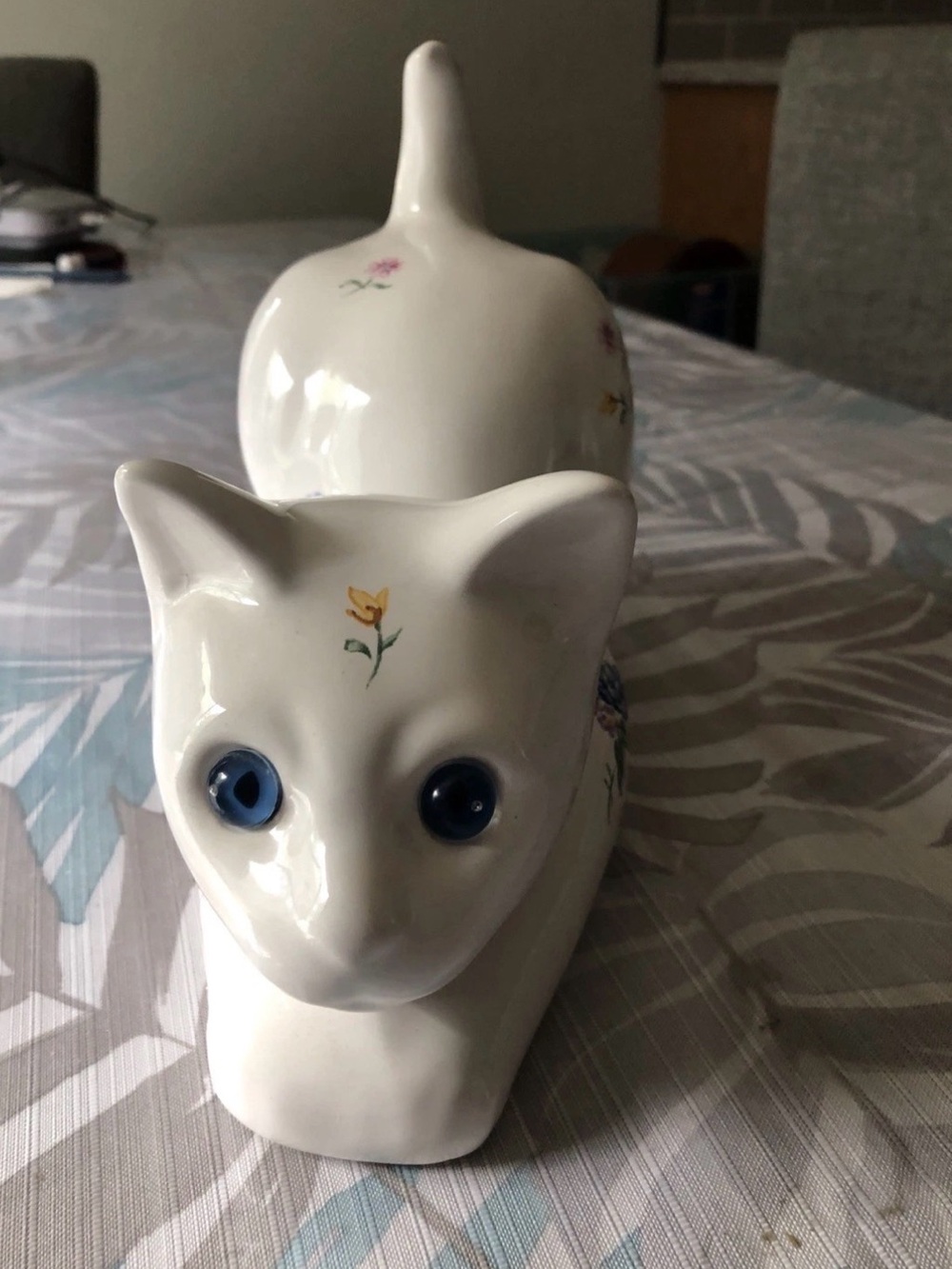 Vtg White Ceramic Cat Laying Down With Floral print  And Glass Eyes - 10” Long